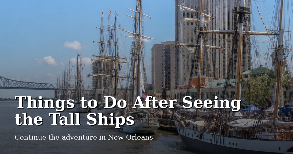 Tall ships docked by a waterfront with city buildings in the background.